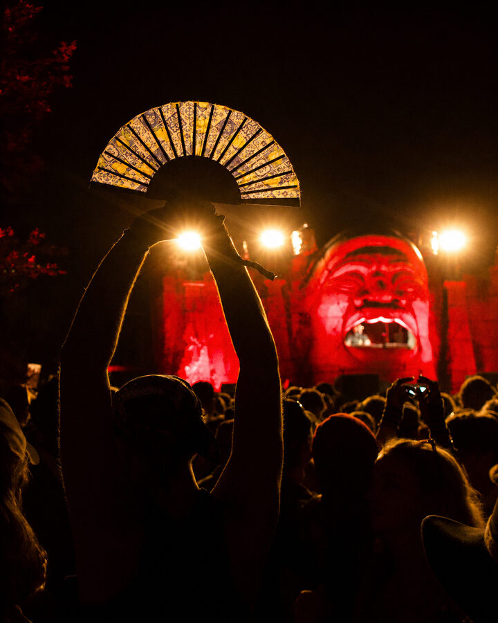 Festival crowd silhouette with hand fan