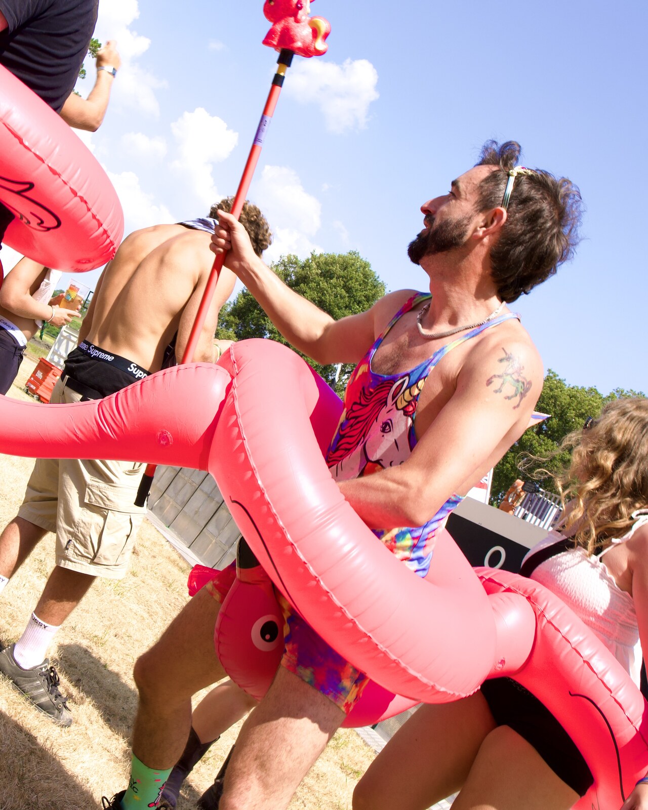 Man with inflatable flamingo ring, festival